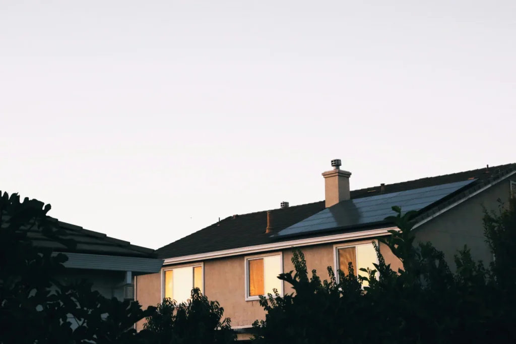 Wohnhaus mit installierter Photovoltaikanlage auf dem Dach bei Sonnenuntergang – Elektrotechnik -Level Up